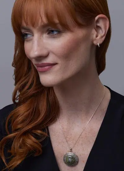 Red haired model wearing Sterling Silver Connemara Marble Trinity Dome Pendant